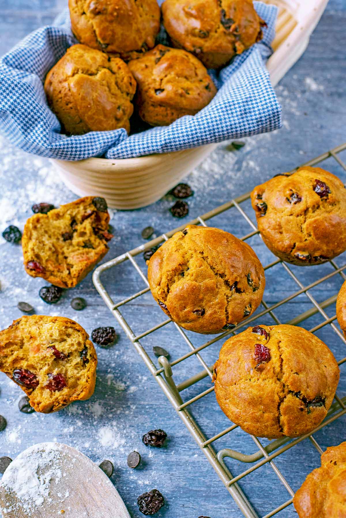Cranberry Orange Muffins on a wire rack with more muffins in the background.