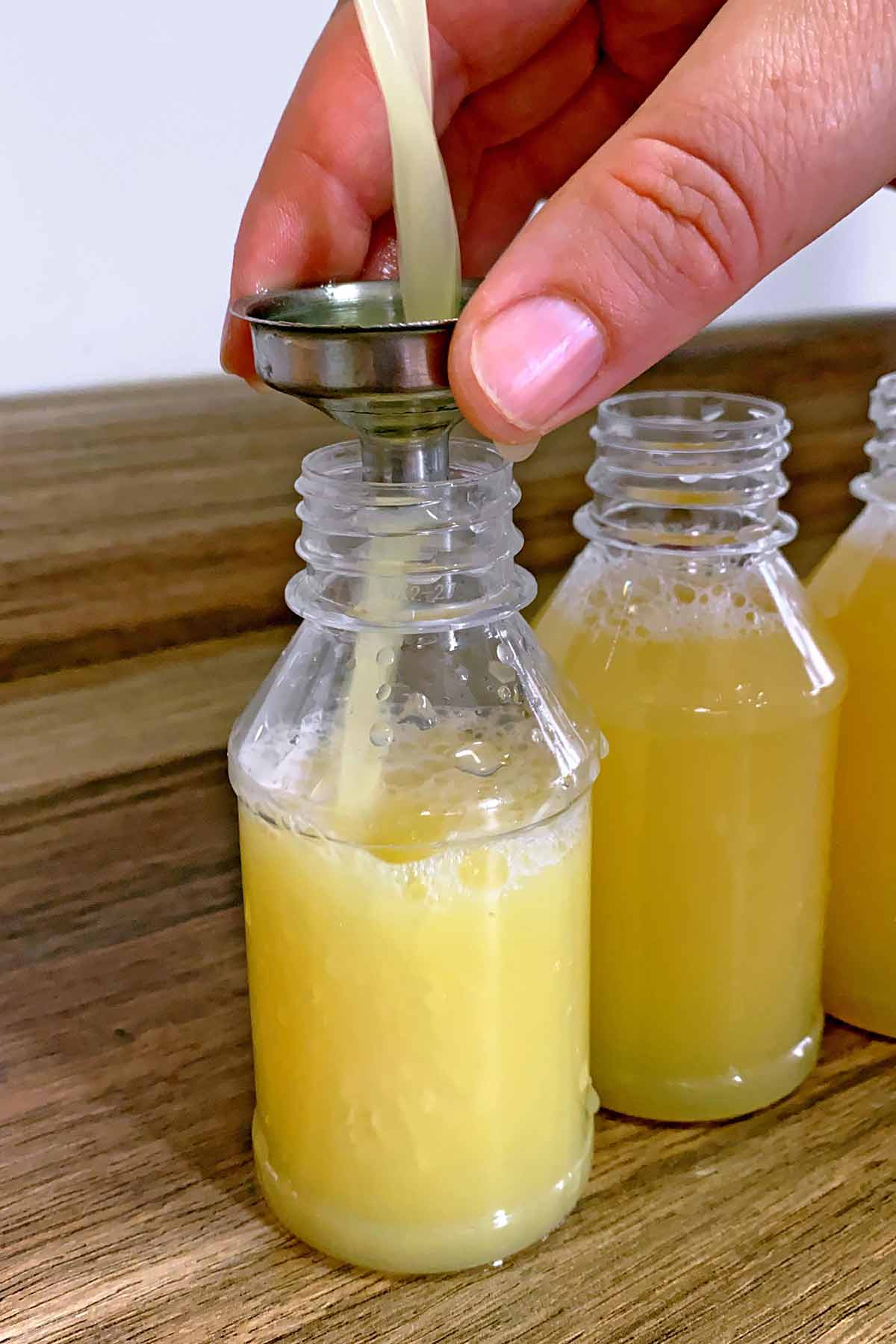 Juice being poured into small bottles.