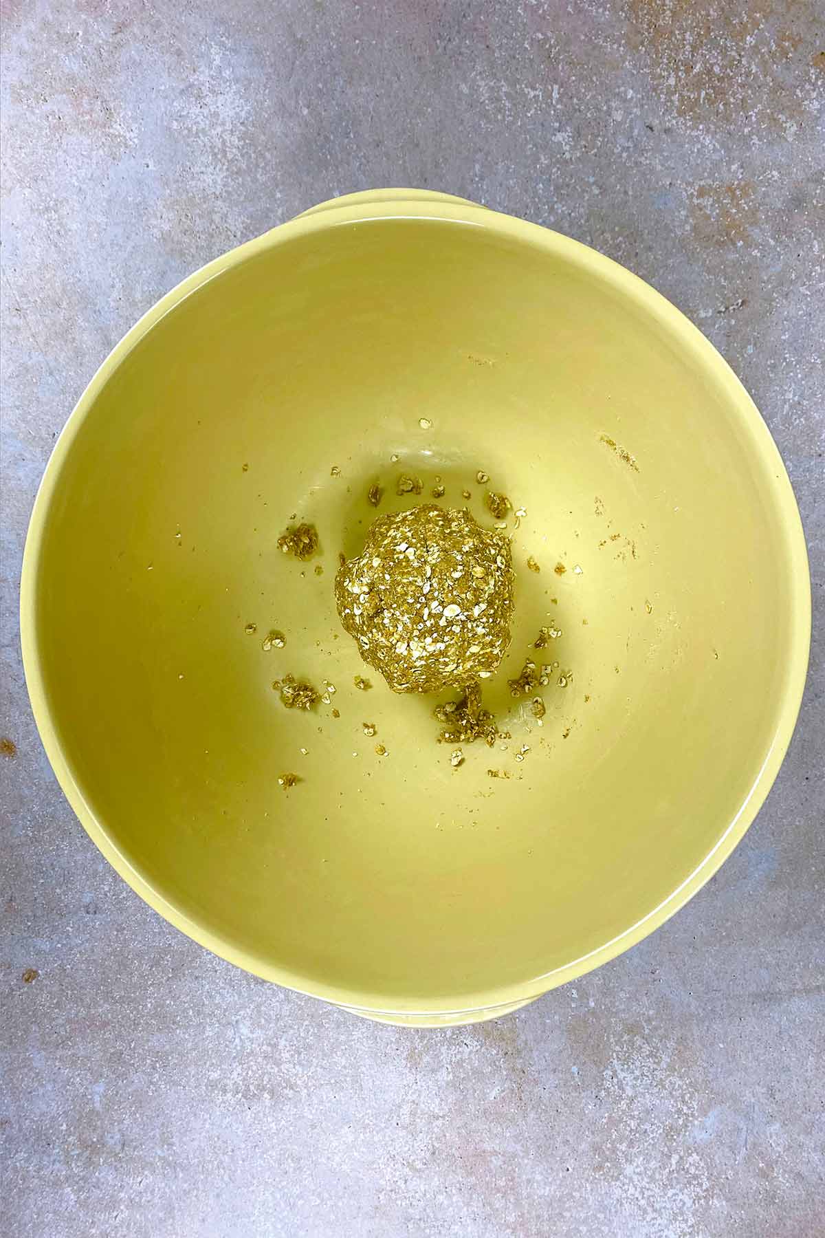 A ball of cookie dough in a large mixing bowl.