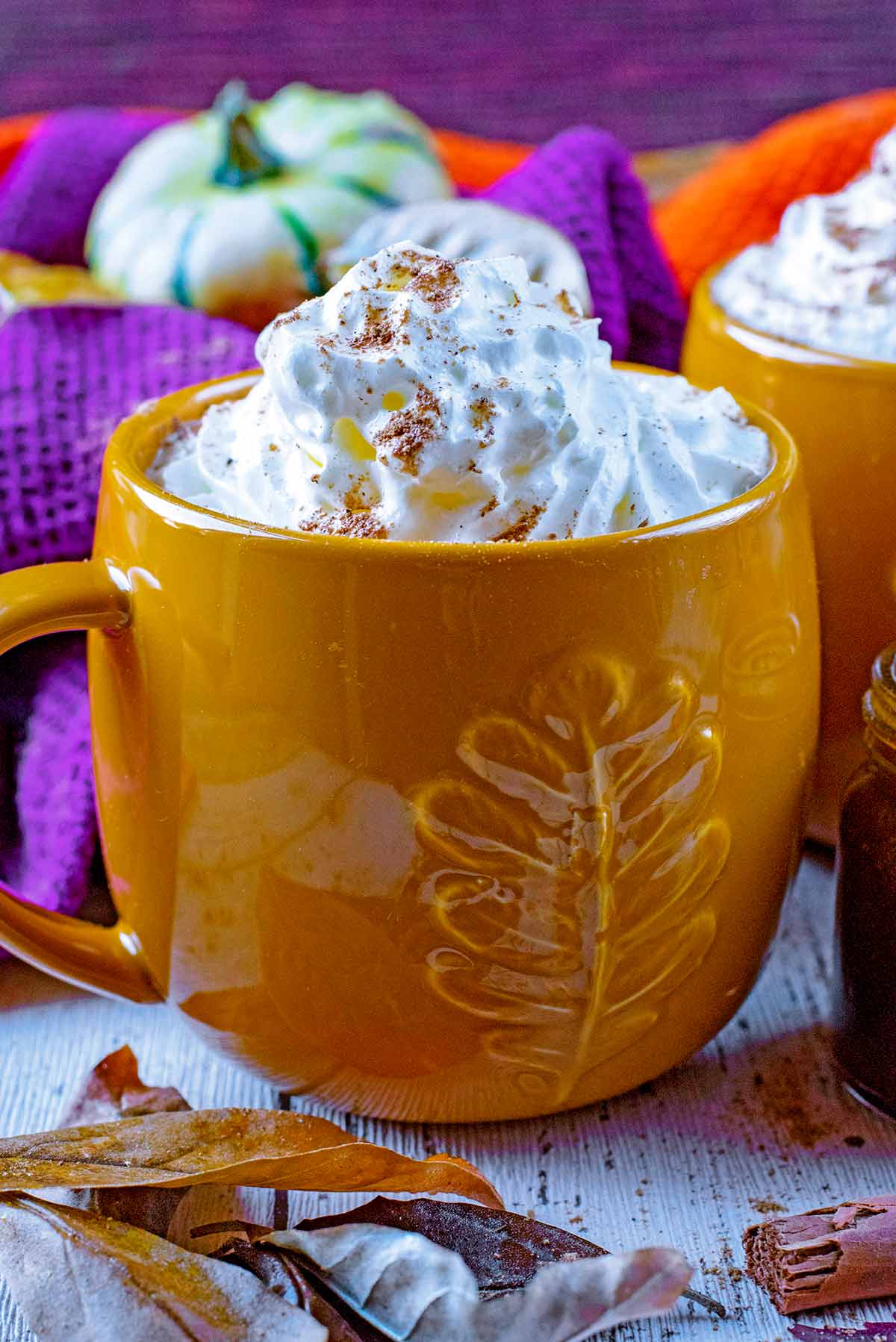 A mug of cream topped pumpkin spiced latte.