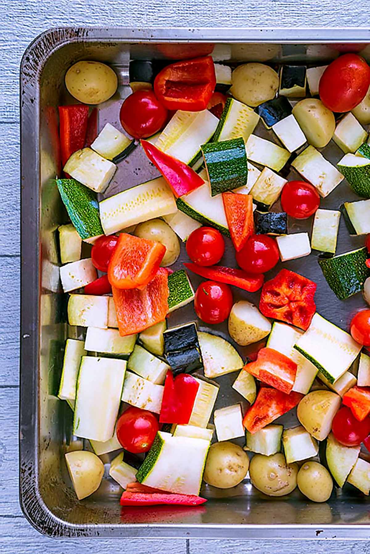 Chopped vegetables in a roasting tin.