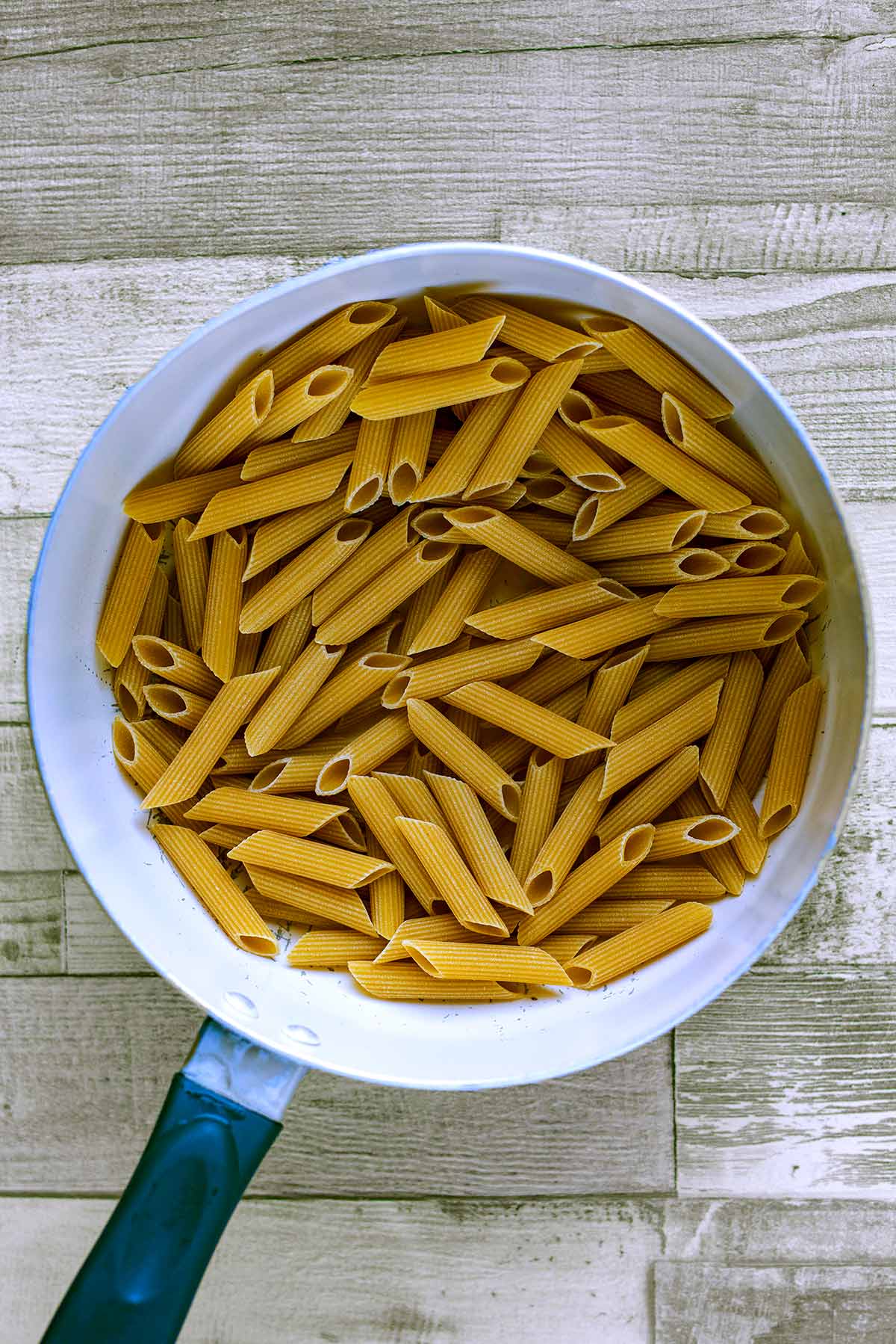 A saucepan full of penne pasta.