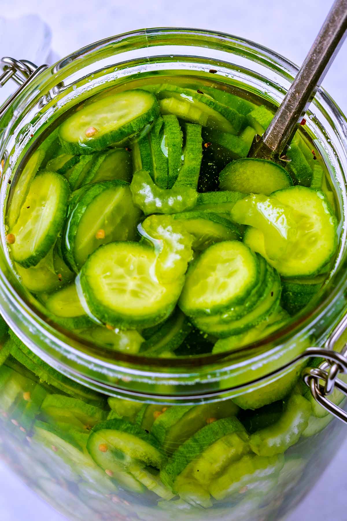 The view looking down into a jar of pickled cucumbers.