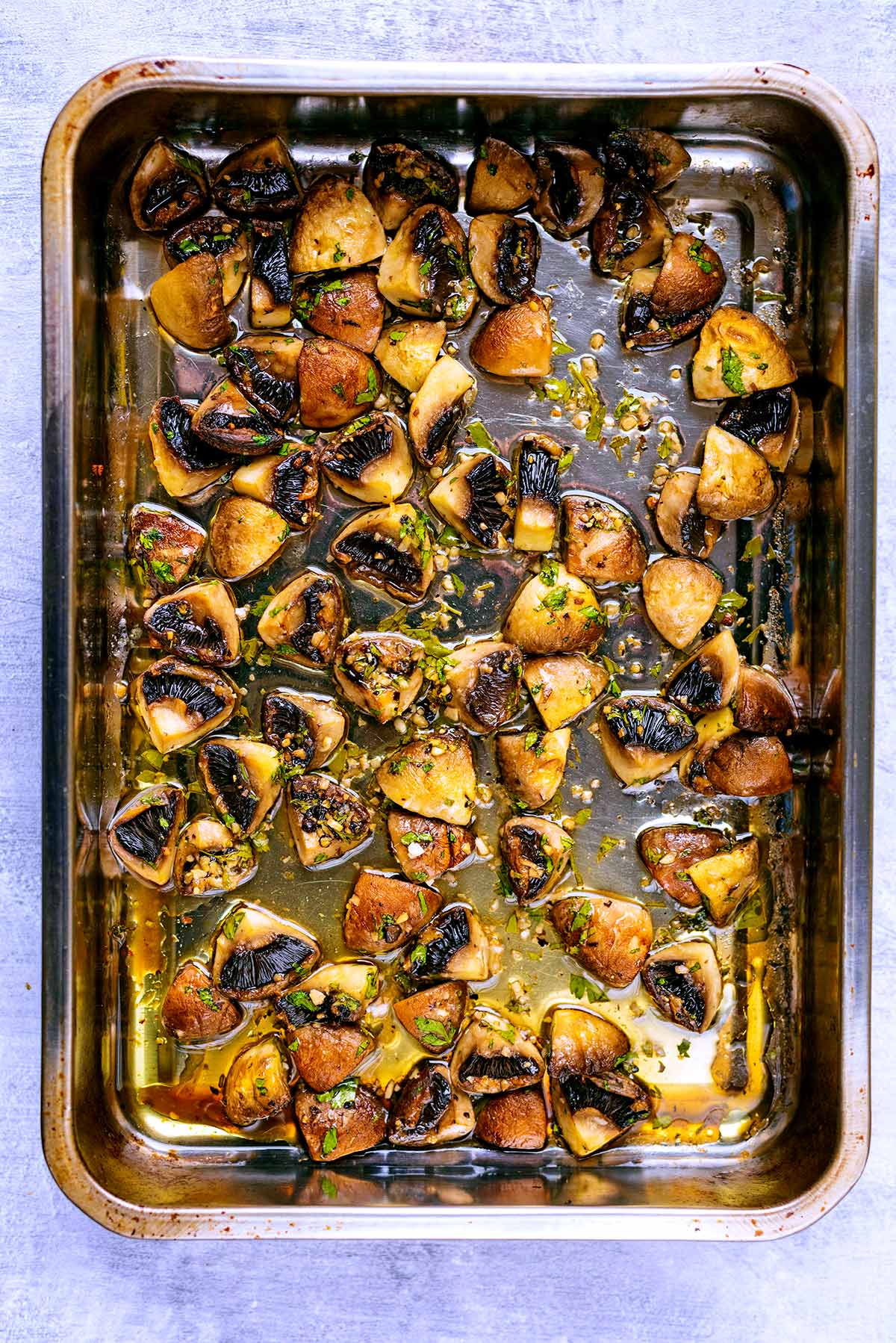 Chopped roasted mushrooms in a baking tray.