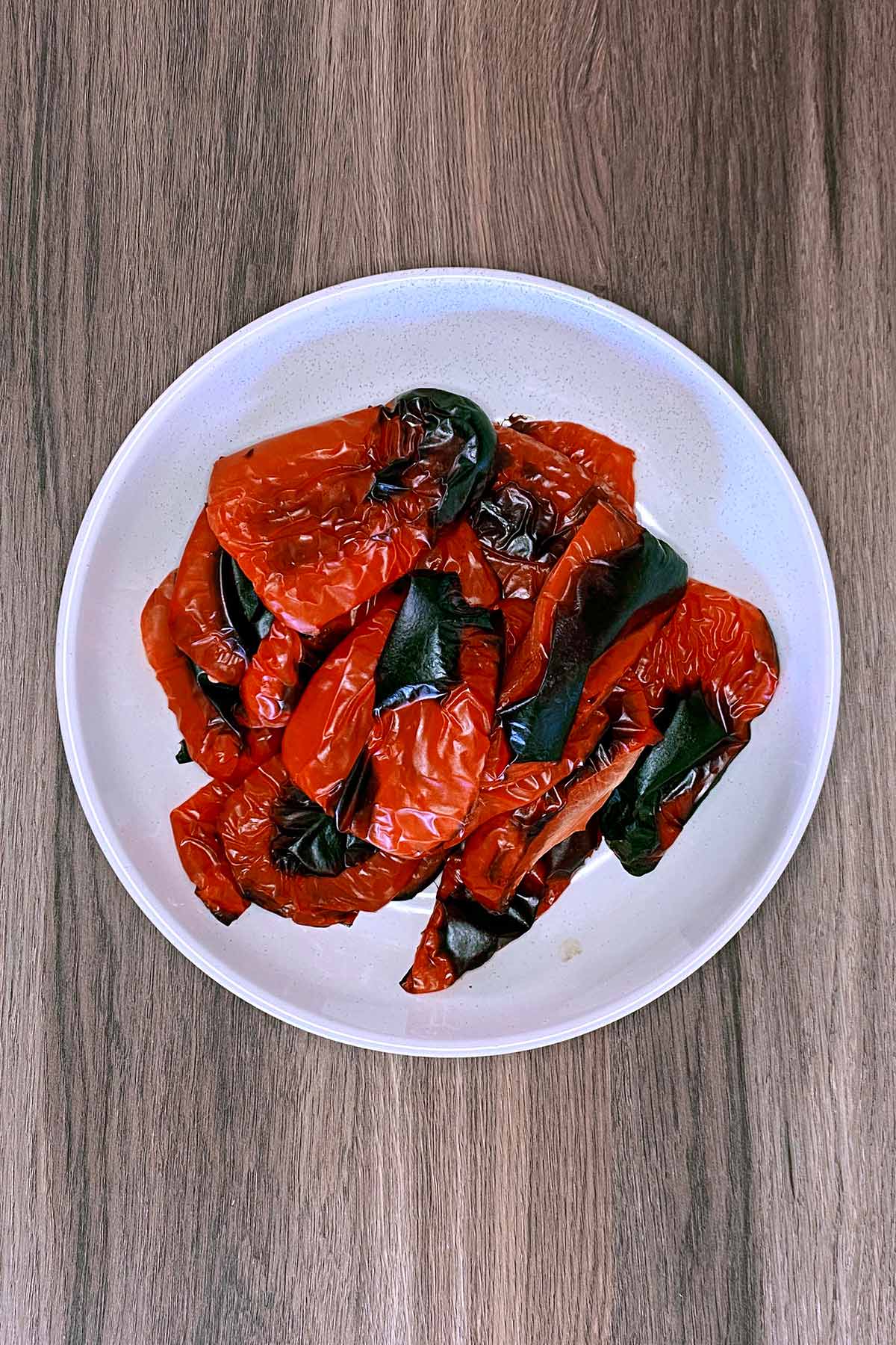 A bowl of charred red peppers.