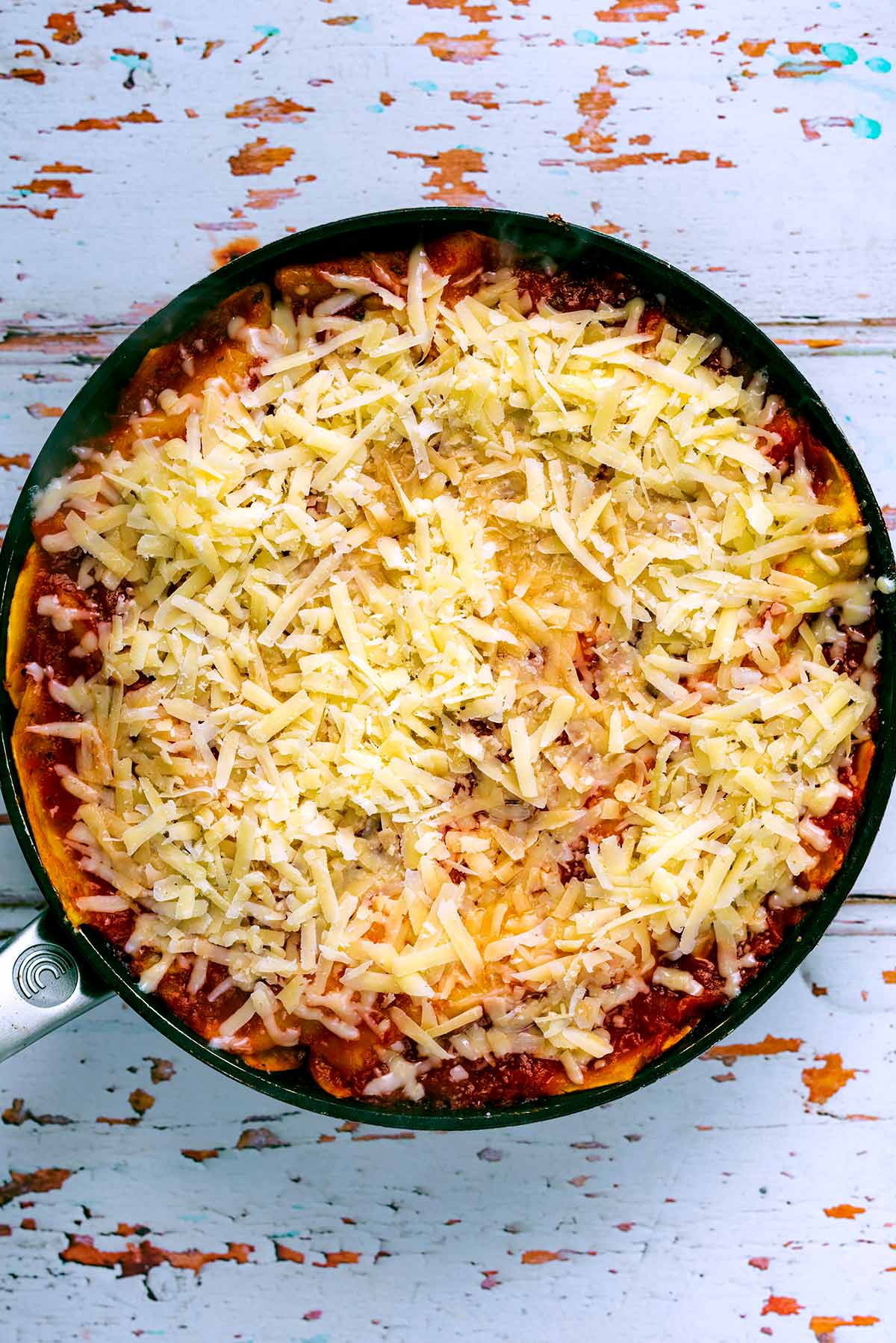 Skillet lasagna topped with grated cheese.