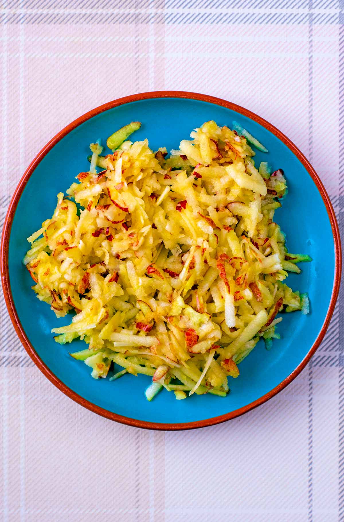 A plate with grated apple on it.