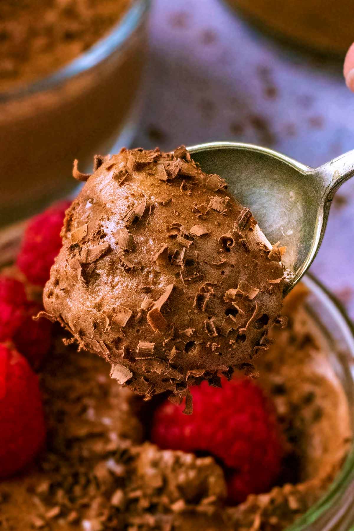 A teaspoon scooping some chocolate mousse.