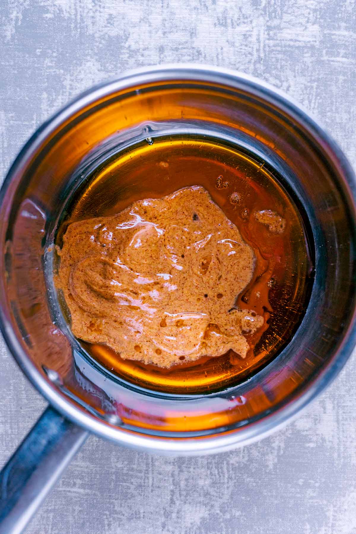 A saucepan with nut butter melting in it.