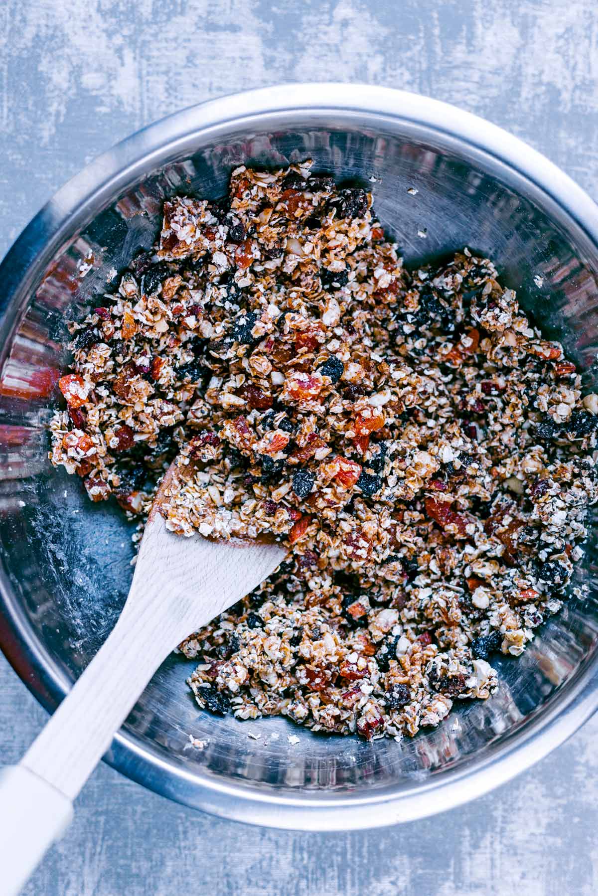 An oat, nut butter and dried fruit mixture in a bowl.