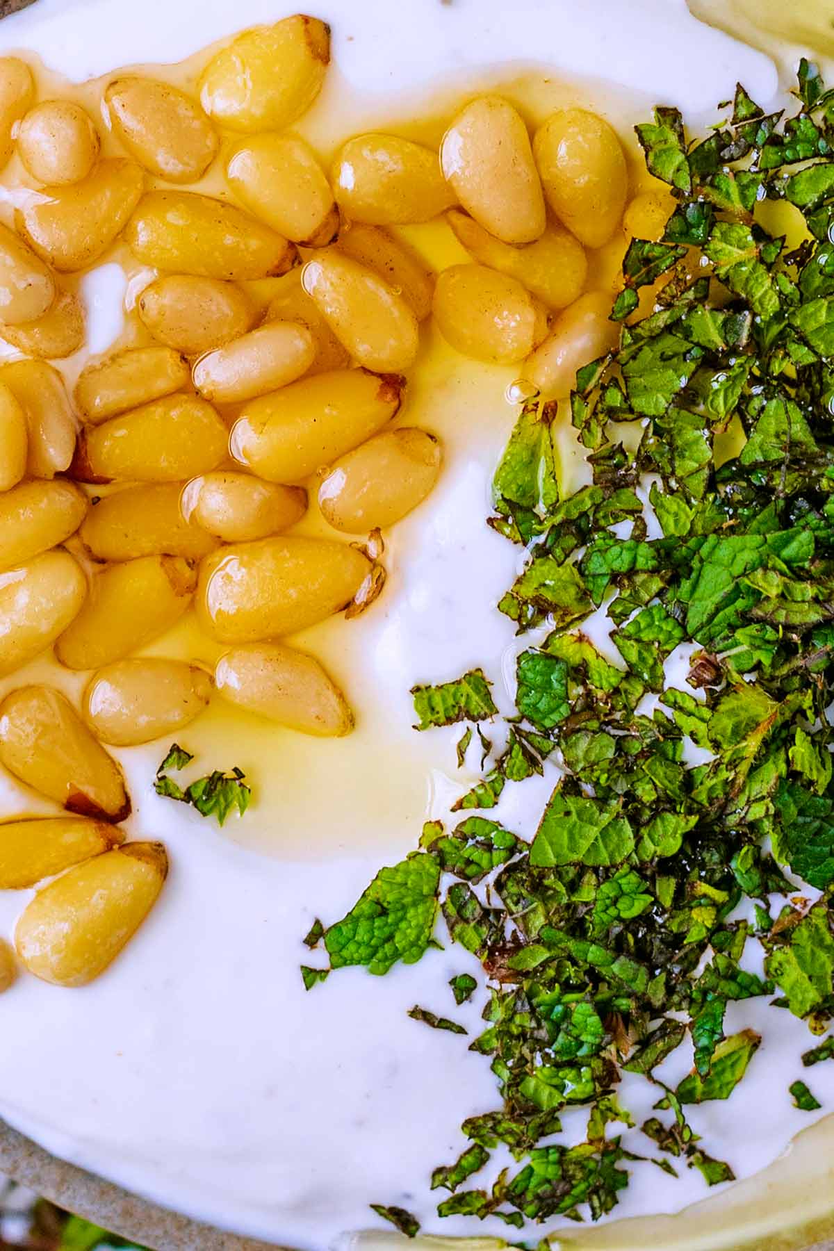 Pine nuts and chopped mint on top of whipped feta.