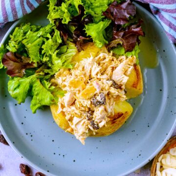 Coronation chicken on top of a baked potato.