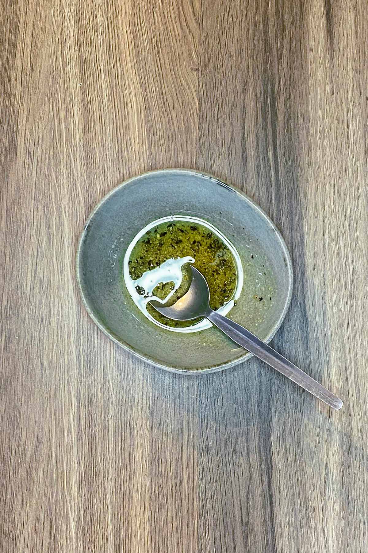 A small bowl of oil based dressing.
