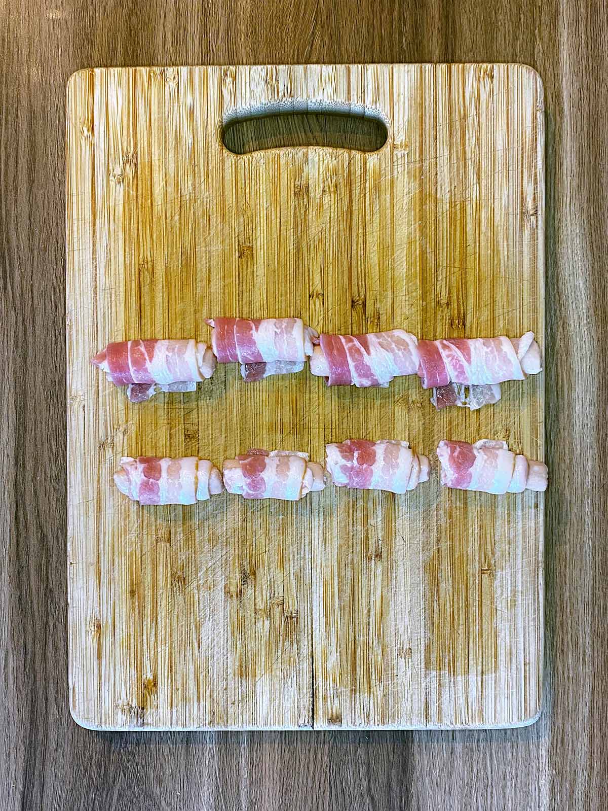 The sausages rolled up in the bacon.