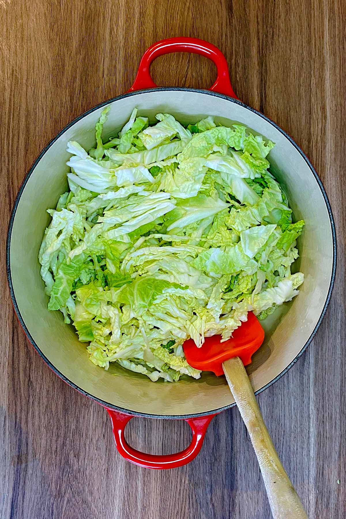 Shredded cabbage added to the pan.