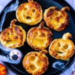 A plate of six mini halloween pies.