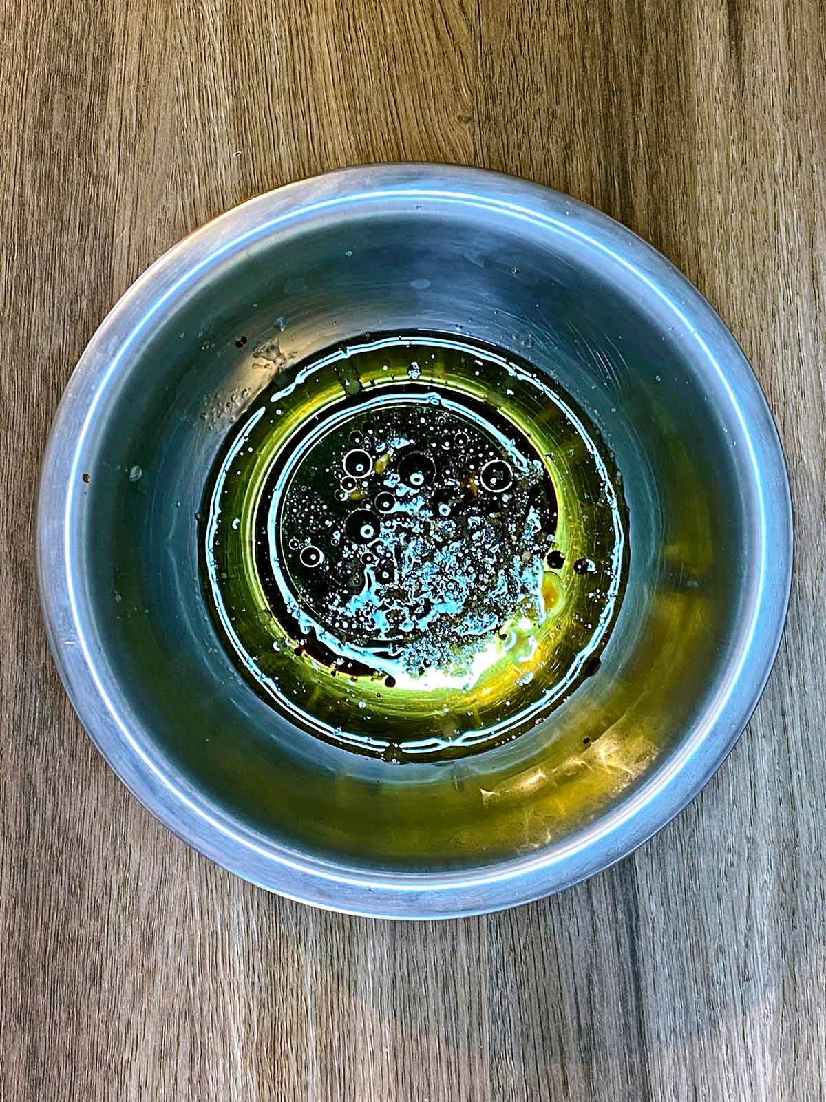 A simple vinaigrette in a small mixing bowl.