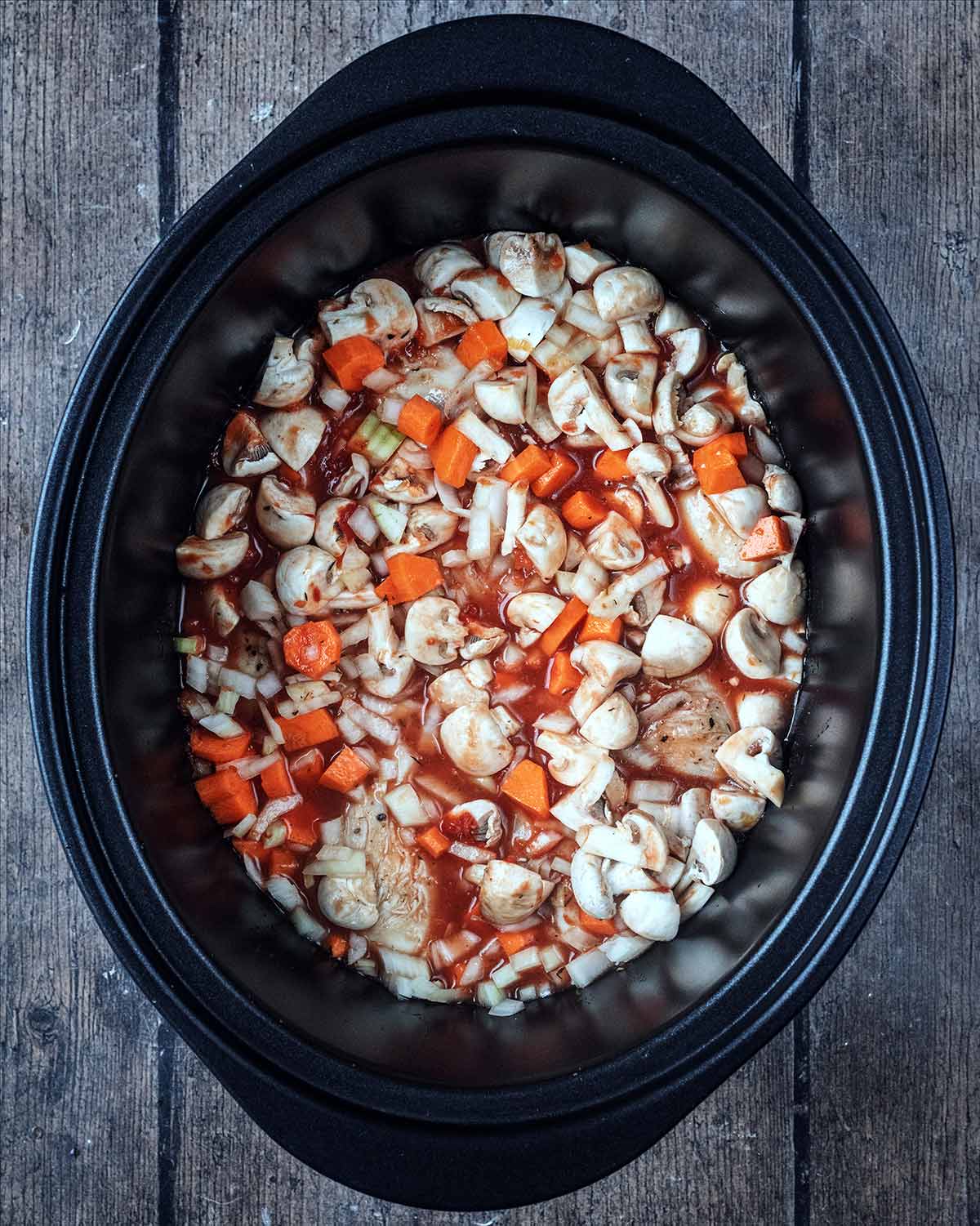 Stock pored into the slow cooker.