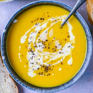 Slow Cooker Vegetable Soup in a bowl with a spoon.