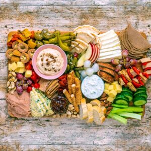 A vegetarian charcuterie board on a wooden surface.