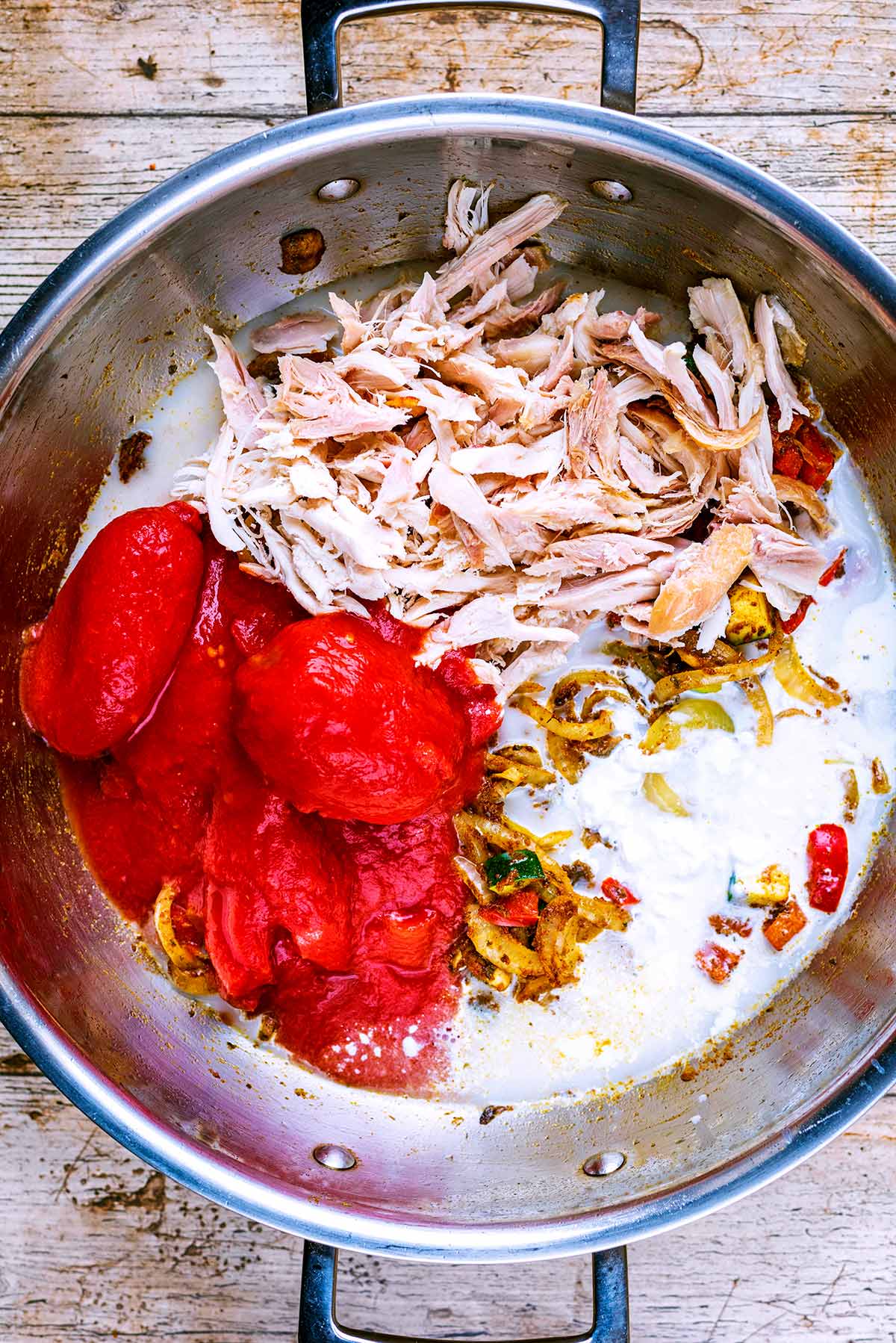 Tomatoes, shredded cooked turkey and coconut milk added to the pan.