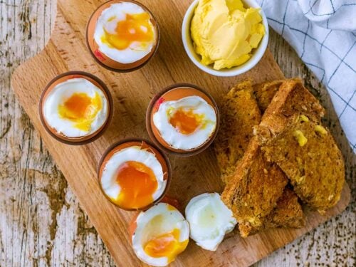 Four air fryer boiled eggs with the tops removed.
