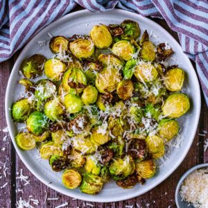 Air fryer Brussels sprouts on a large round plate.
