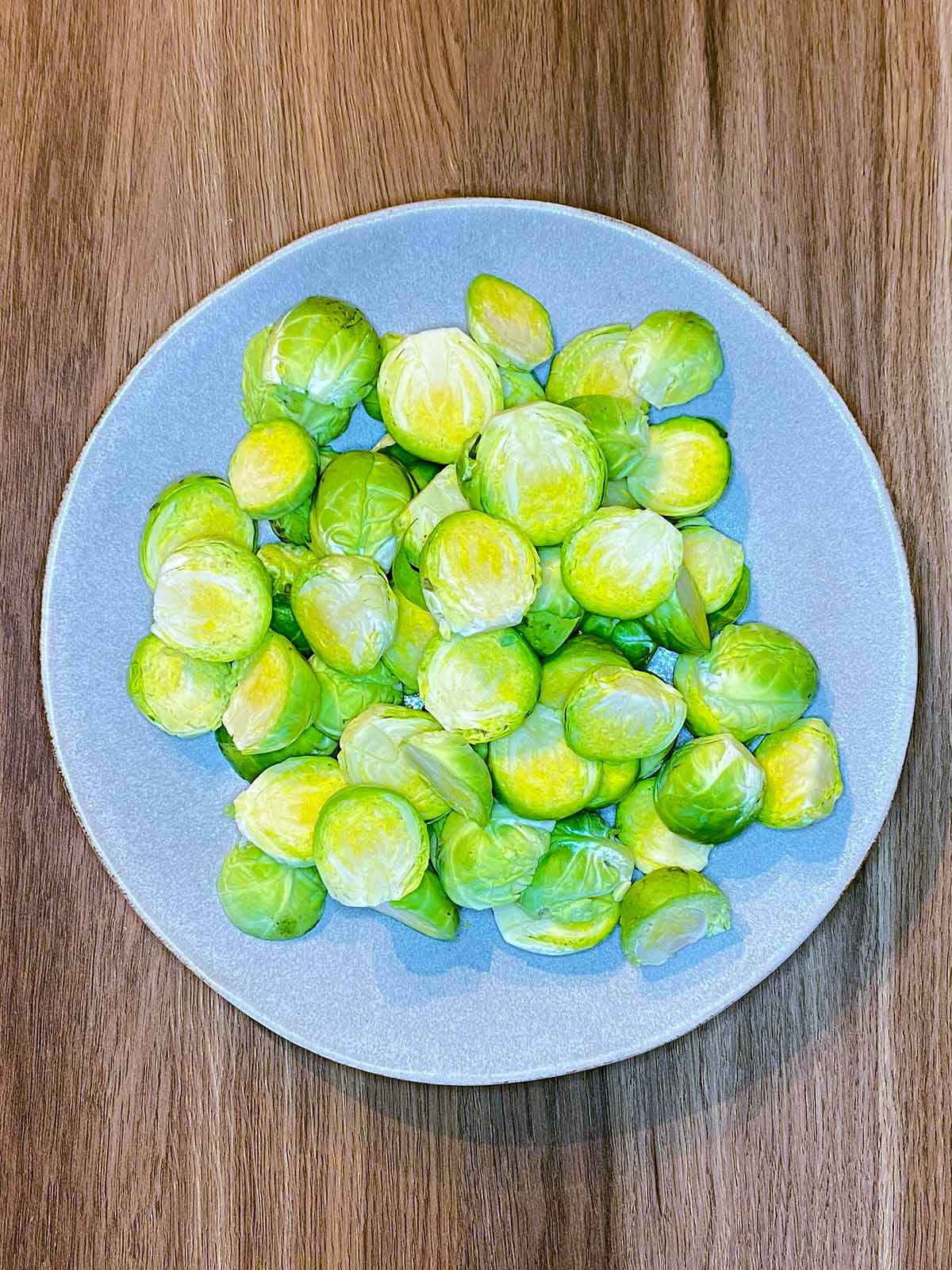 A plate of halved Brussels sprouts.