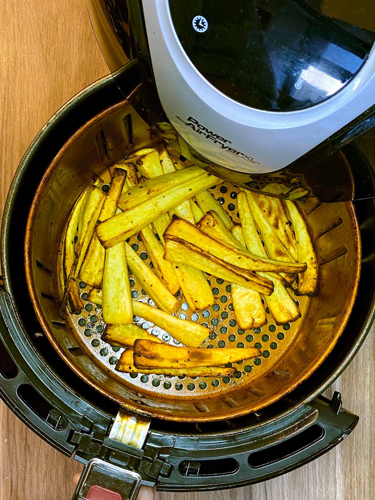 Cooked parsnips in an air fryer.