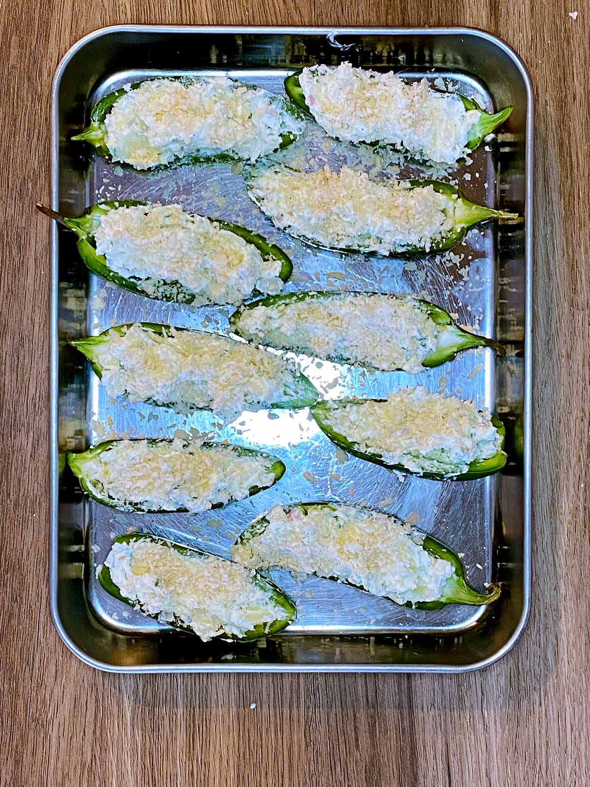 The stuffed jalapenos on a baking tray.
