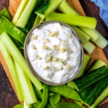 A small bowl of Blue Cheese Dip surrounded by crudites.