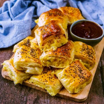 Cheese and onion rolls on a serving board.