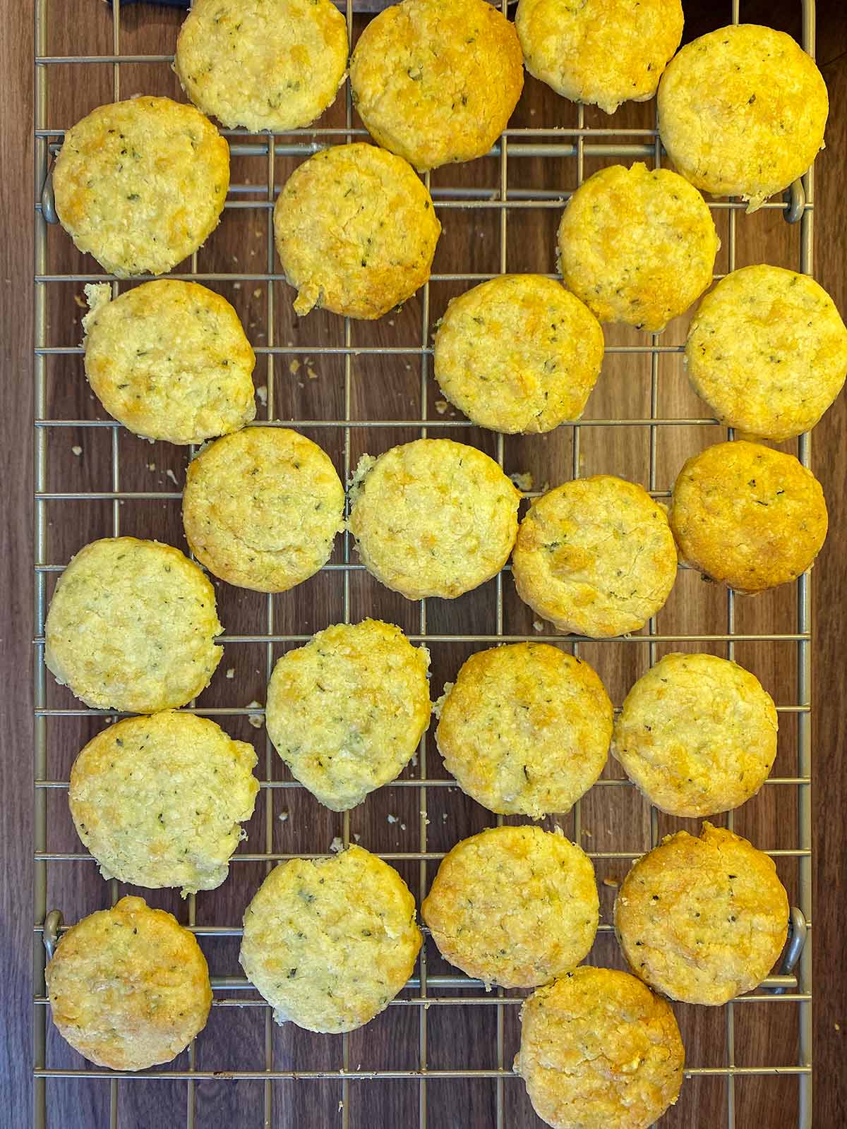 Cooked cheese biscuits on a wire cooling rack.