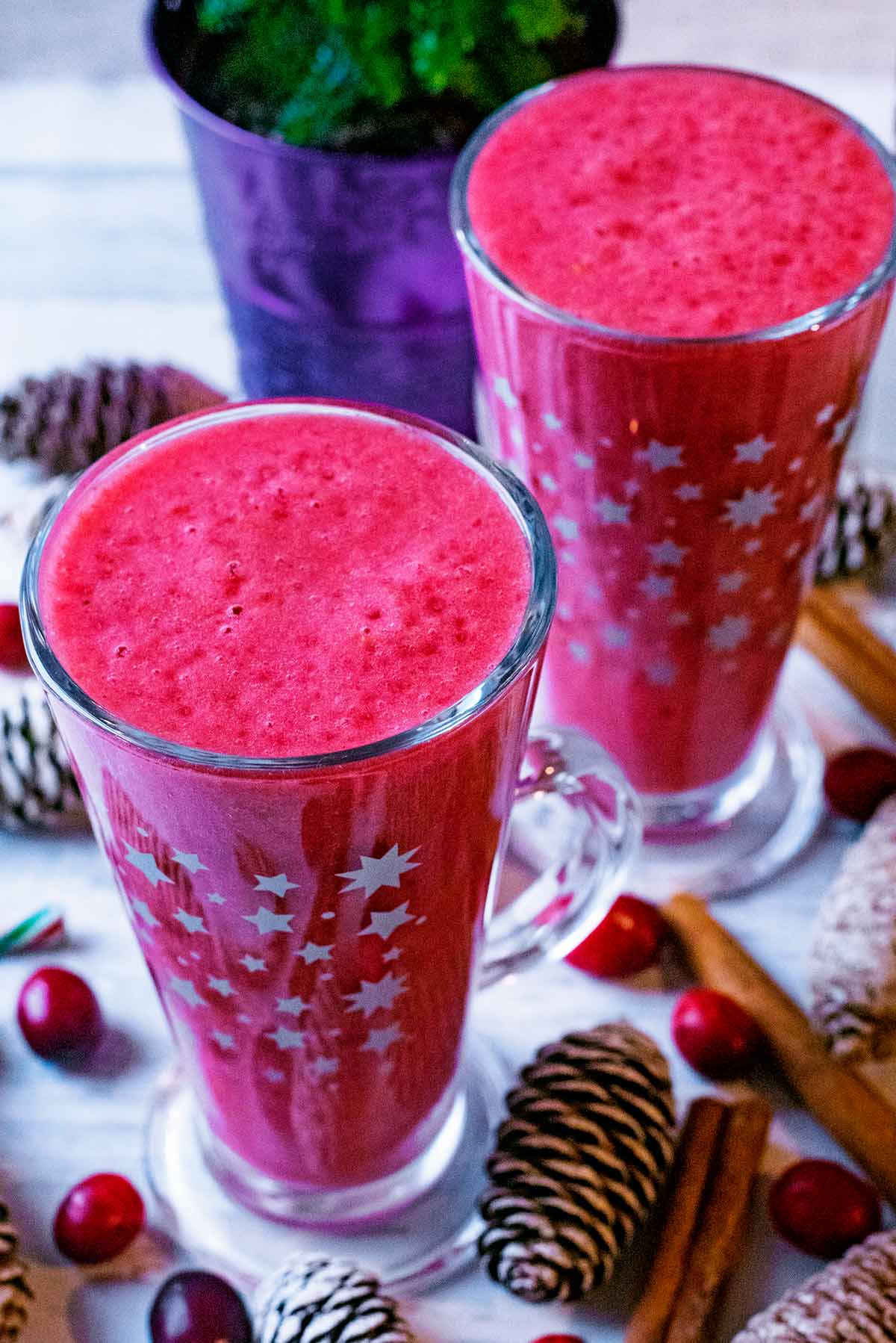 Two tall glasses of cranberry smoothie.
