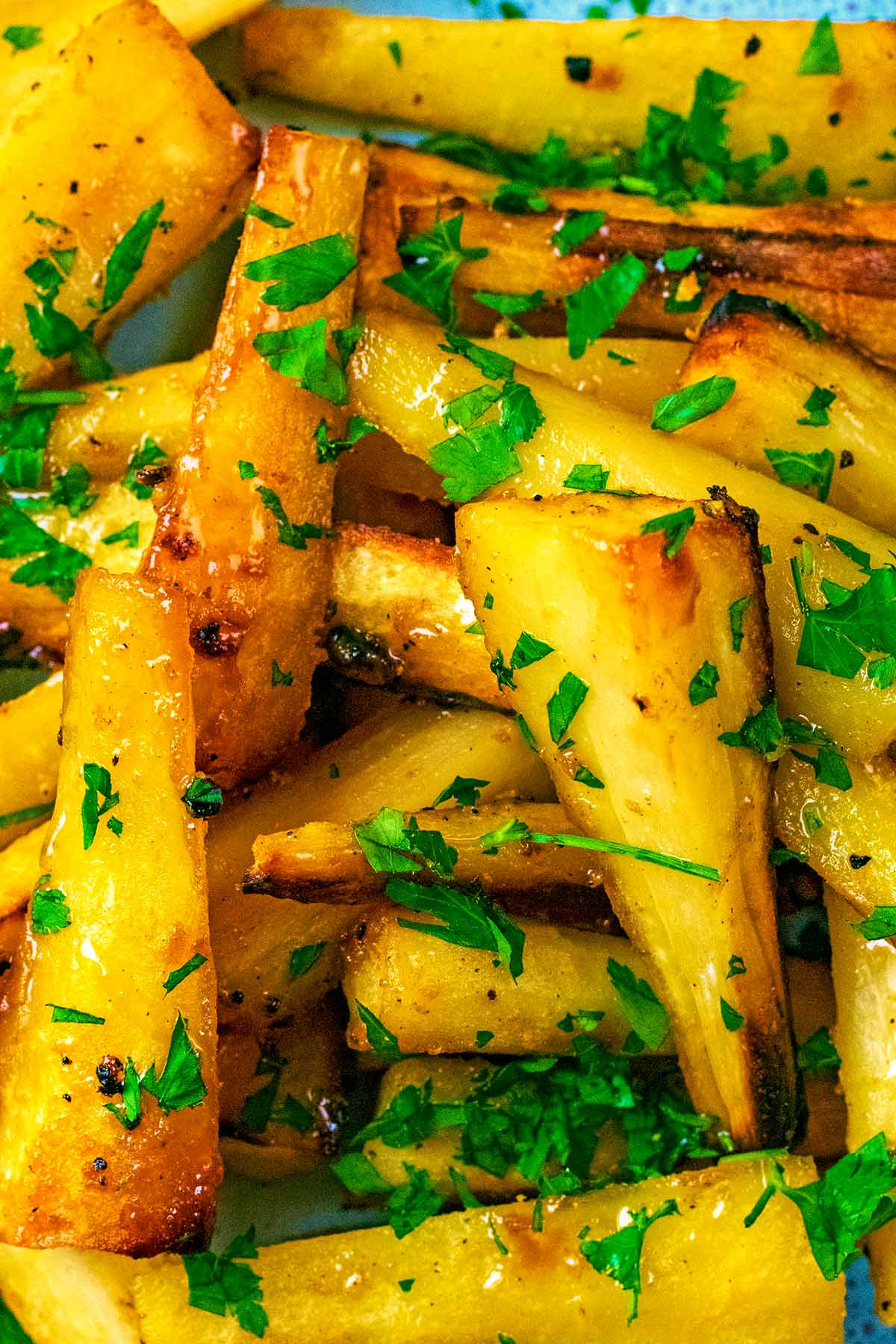 Mustard and honey roasted Parsnips with chopped parsley on top.