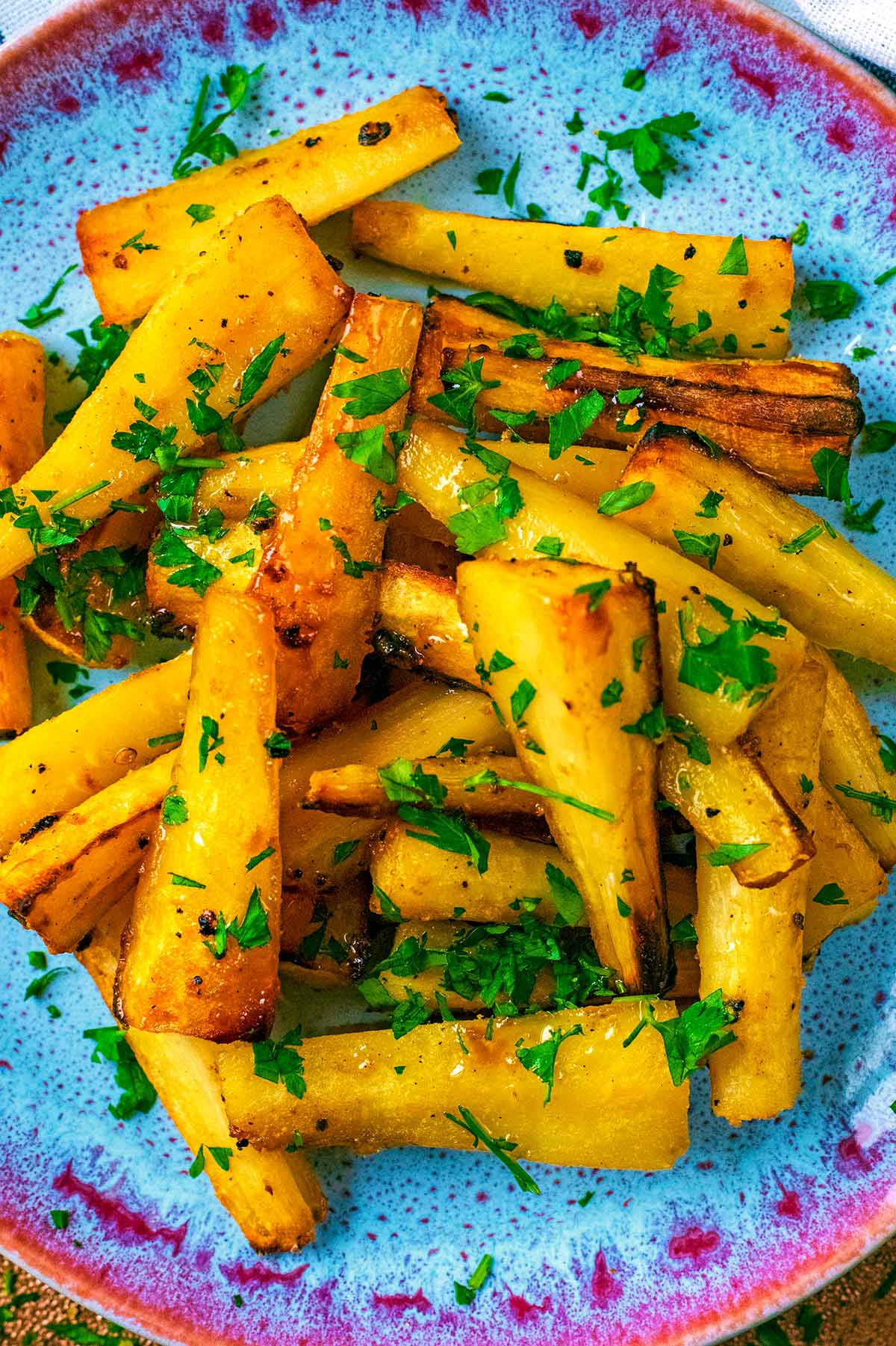 Honey Roasted Parsnips on a blue plate.