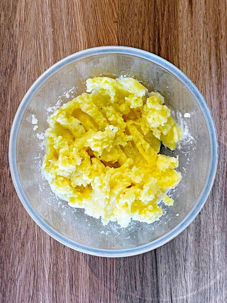 Cooked mashed potato in a glass bowl.