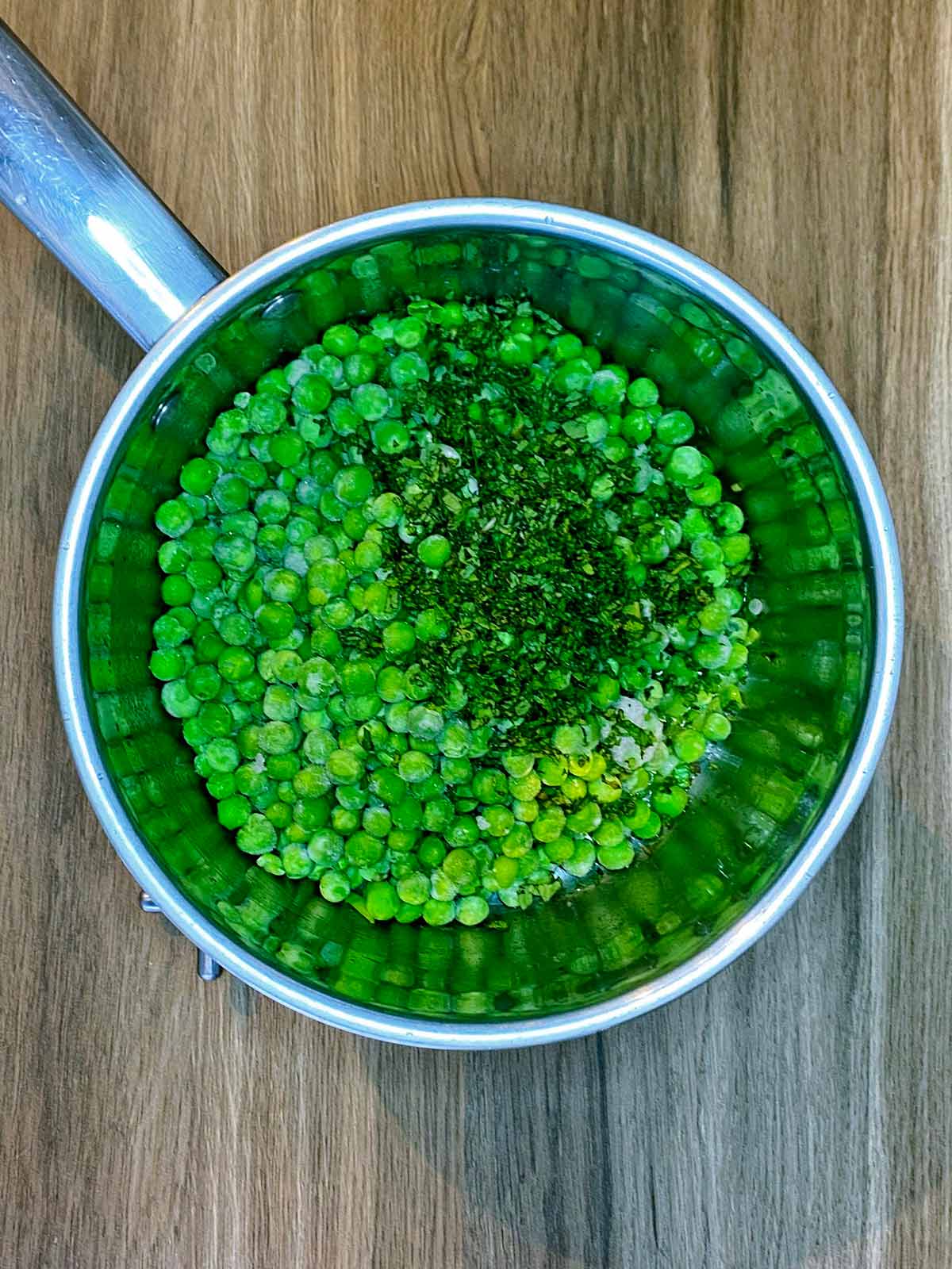 Frozen peas and chopped mint added to the pan.