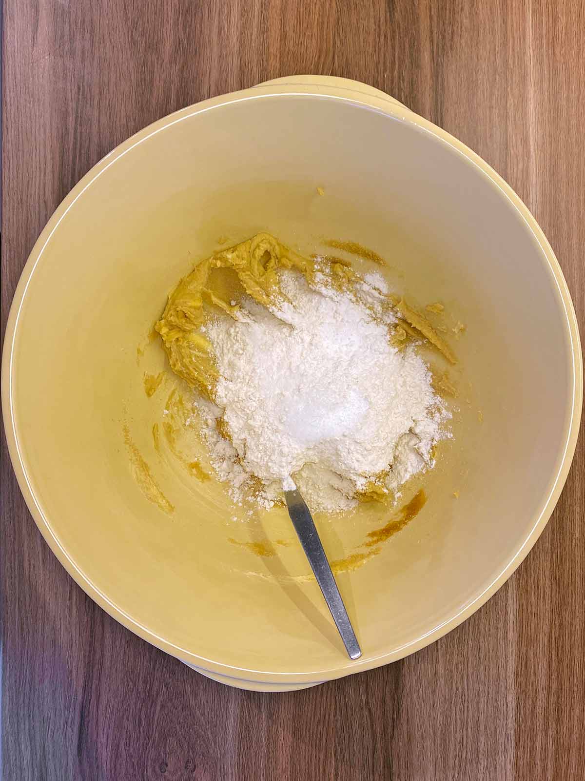 Flour, baking powder and baking soda added to the bowl.