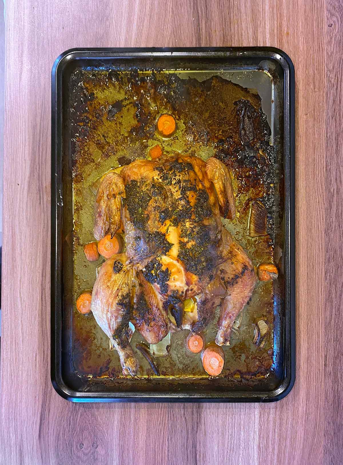 Roast chicken on a baking tray.