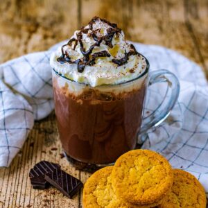 A glass mug full of microwave hot chocolate.