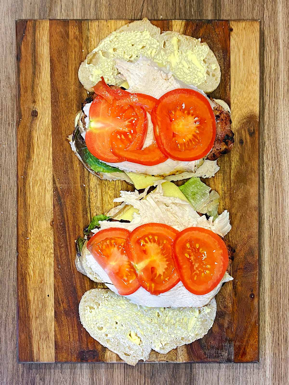 More turkey and sliced tomatoes added to the sandwich.