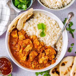 Slow cooker chicken tikka masala in a bowl with rice.