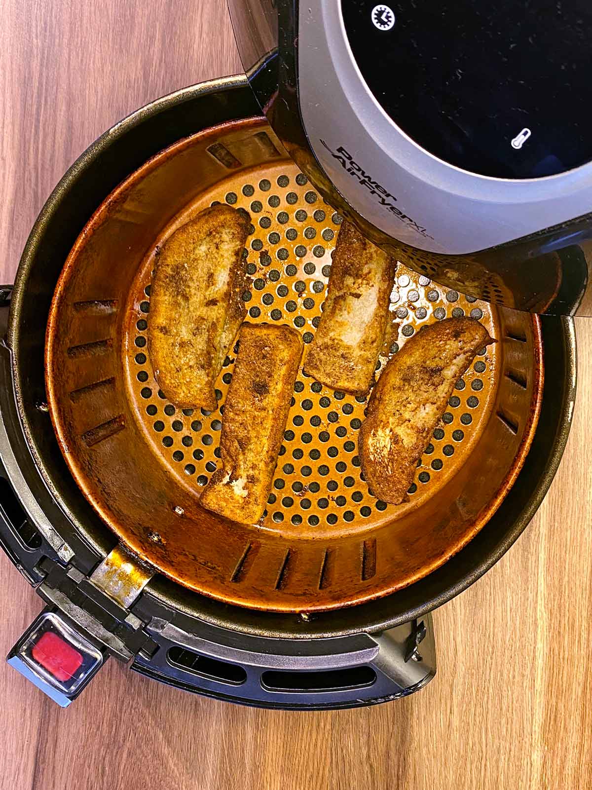 Cooked French toast in an air fryer.