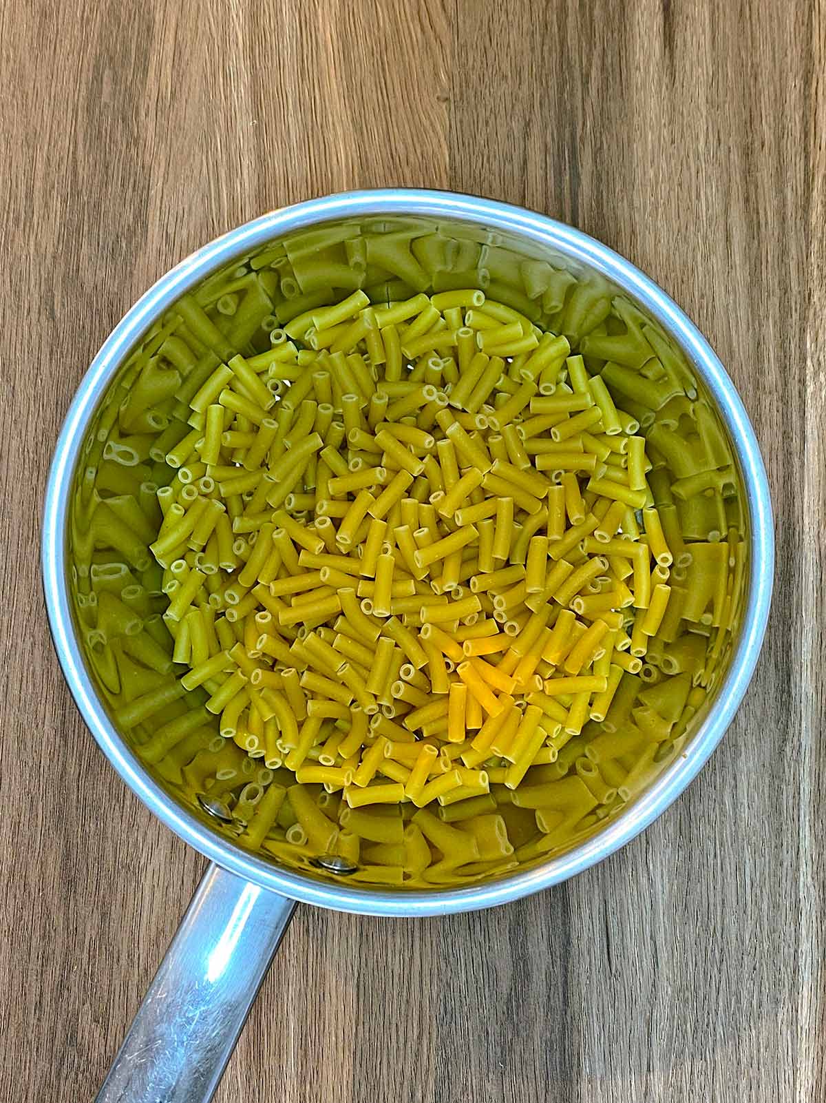 A saucepan containing uncooked macaroni.