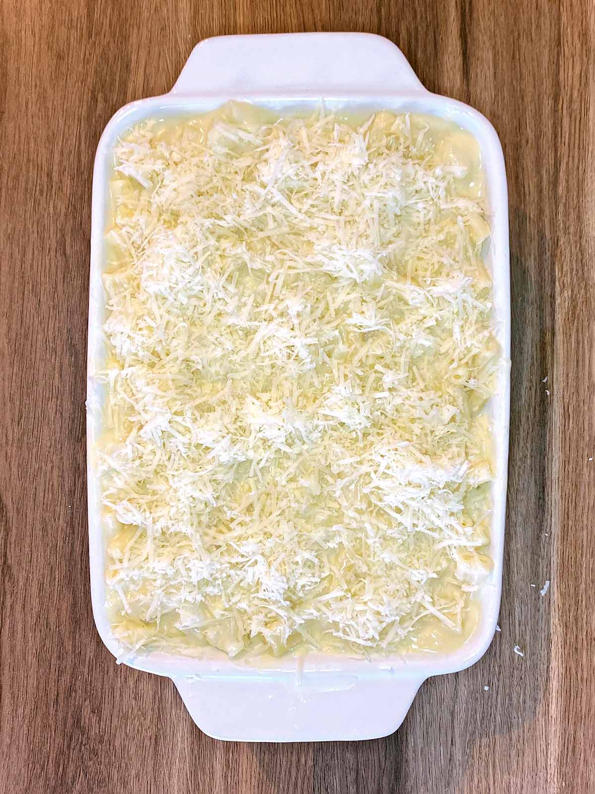 Grated cheese added to the top of the cheesy pasta.