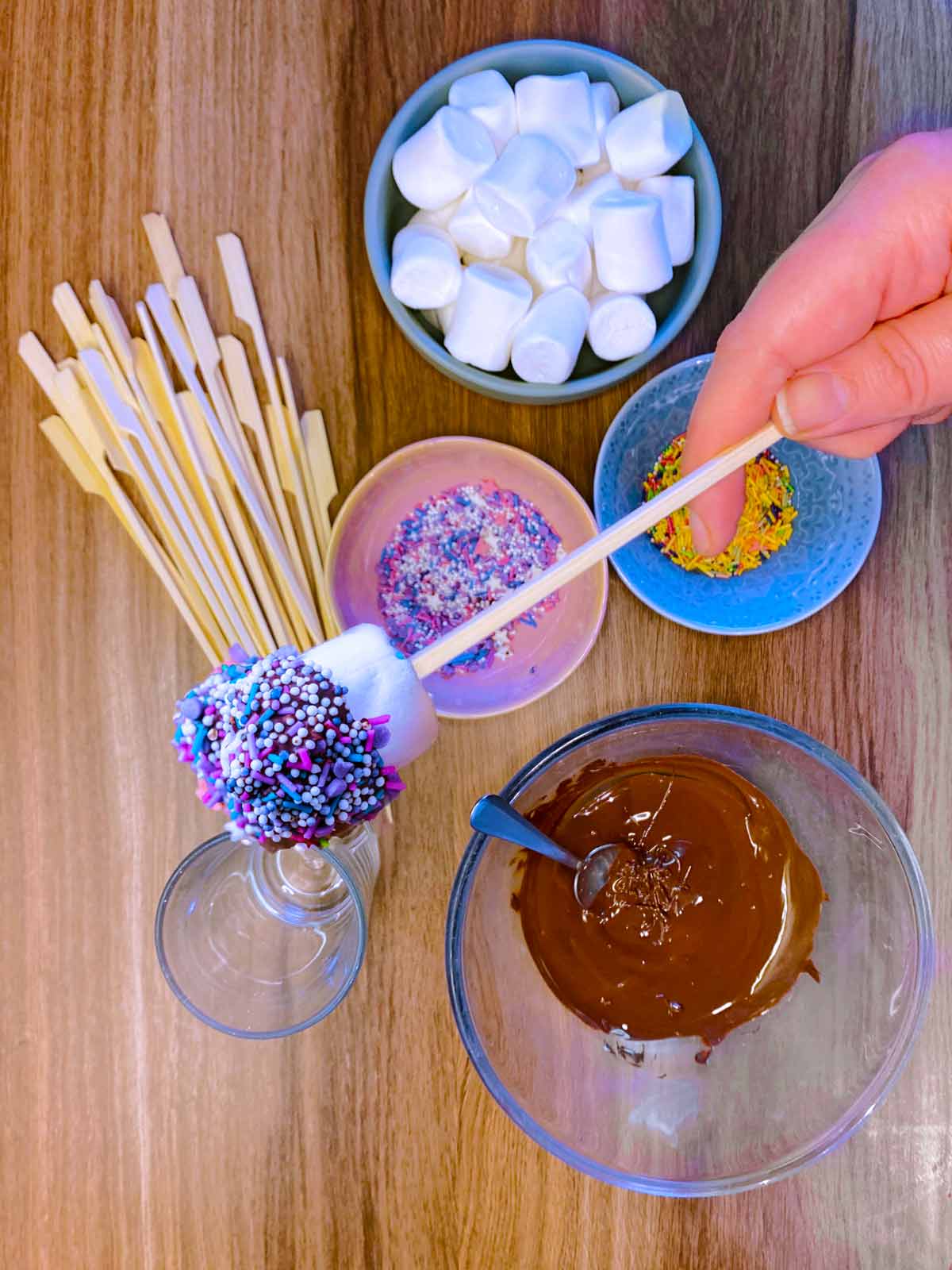 A marshmallow that has been dipped in chocolate and sprinkles.
