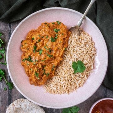 Slow cooker chicken tikka masala in a bowl with rice.