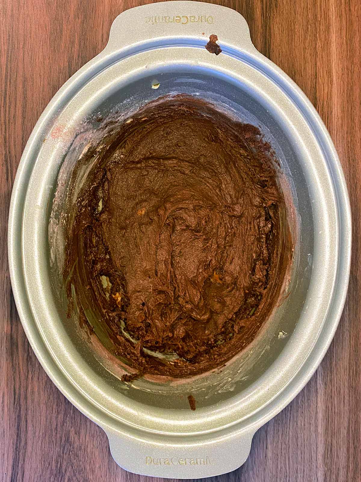 Chocolate cake batter mixed in the slow cooker bowl.