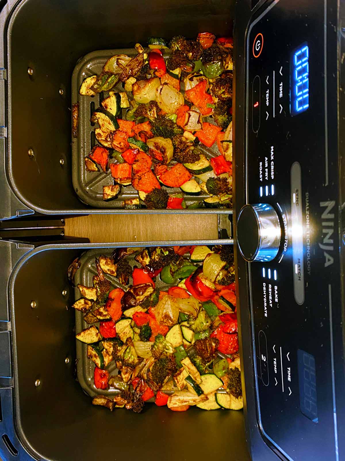 Cooked, chopped vegetables in an open air fryer.